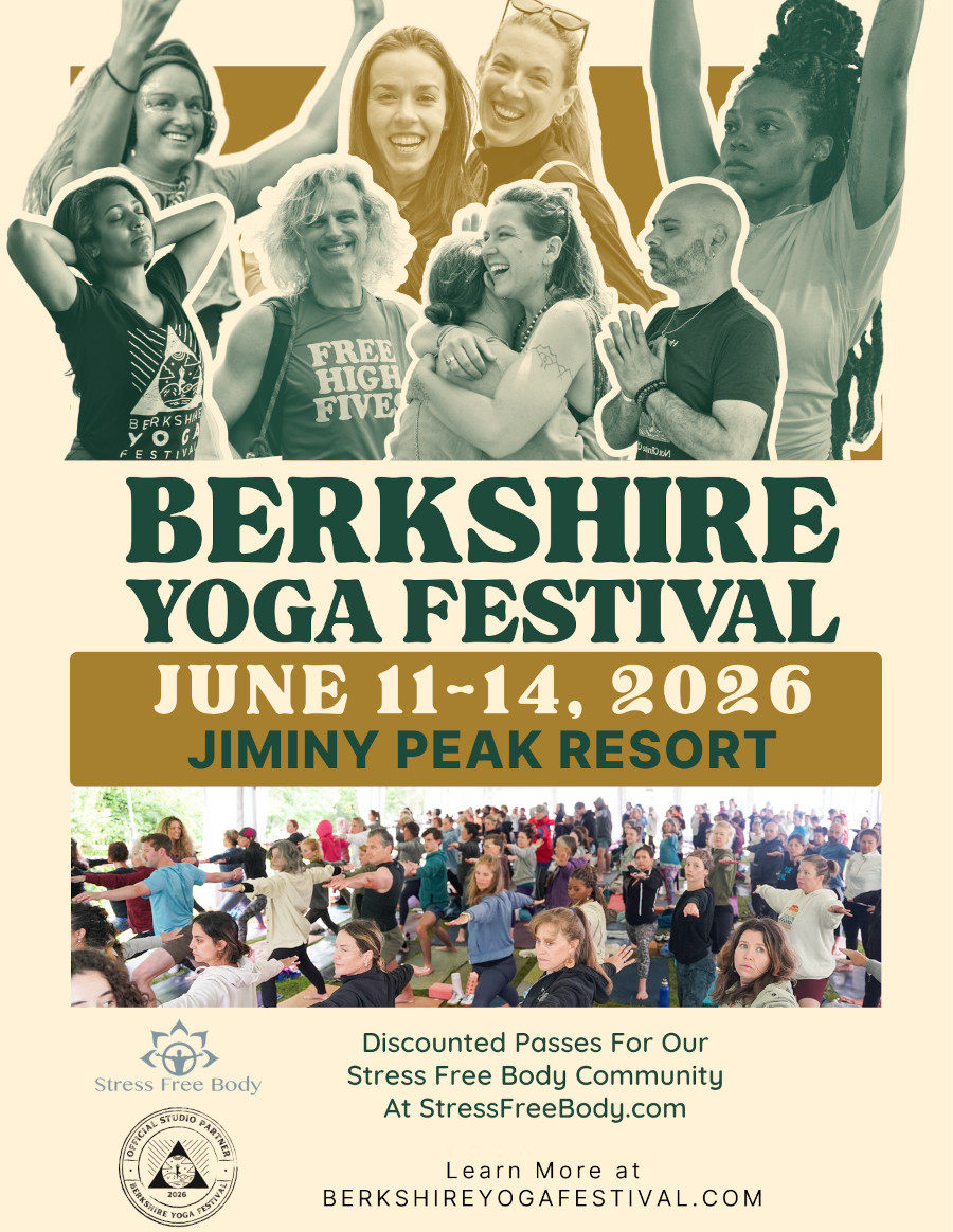 A group of people practicing yoga on a lush green lawn surrounded by trees at the Berkshire Yoga Festival.